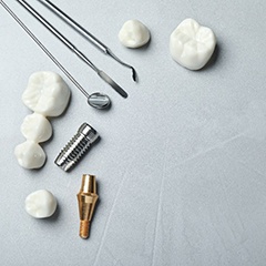 Dental bridges and dental tools against a gray background