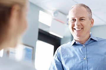 Smiling man at reception desk