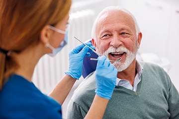 Man smiles at dental hygienist