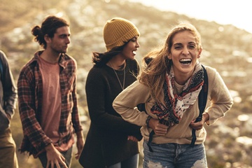 person hiking with their friends and smiling