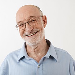 Older man smiling while wearing collared shirt