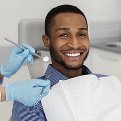 Man smiling in dental chair during his dental checkup