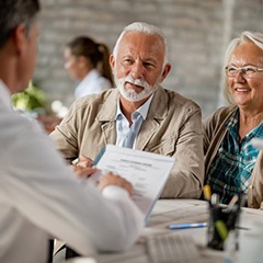 elderly couple at a dental implant consultation