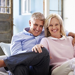 happy elderly couple sitting on a couch