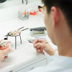 a dental technician working on creating dentures