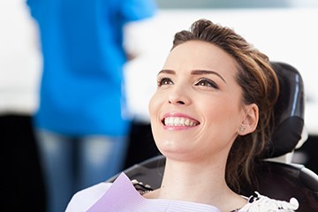 Woman smiles while visiting her Naples dentist