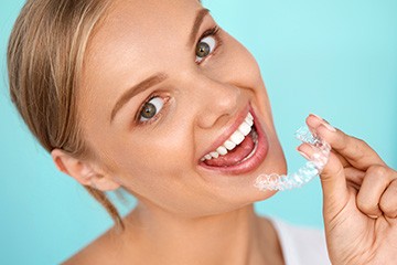 Woman placing invisalign tray