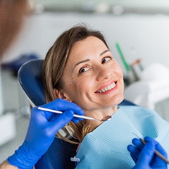 Woman smiling at dentist during exam