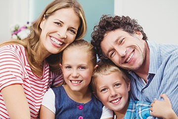 Smiling mother father and two children