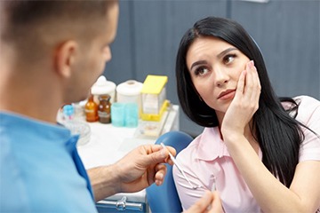 woman in dental chair with toothache