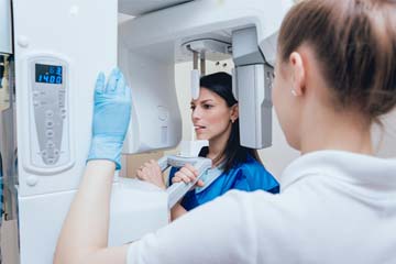 Woman getting x-rays taken at dentist