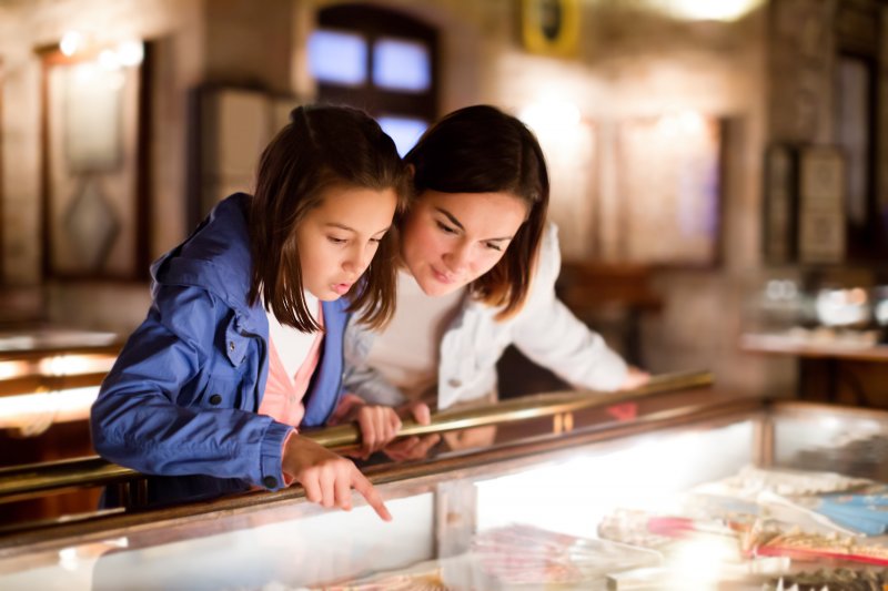 Mother and daughter looking at ancient dental implants