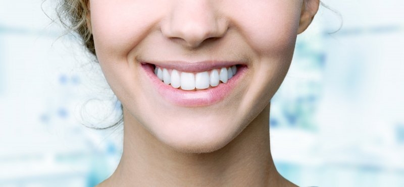 woman smiling after visiting cosmetic dentist in Naples 
