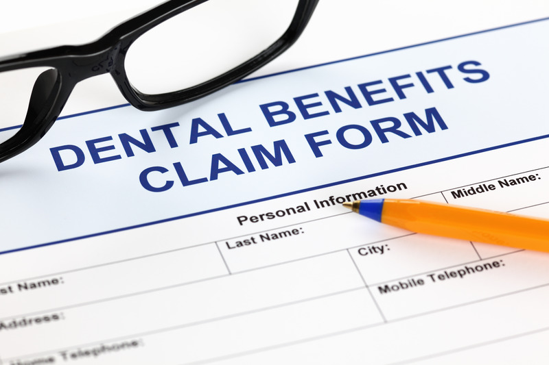 Patient checking dental insurance for dental implants