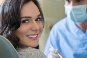 A woman receiving care from a dentist in Naples.